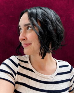 Photo of Rose Santoriello. They have pale skin and short black hair.